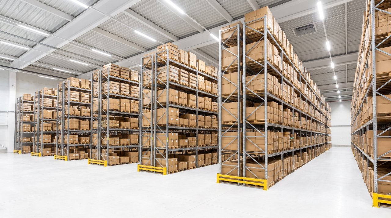 Large warehouse racking system with organized pallets and metal shelving in industrial facility